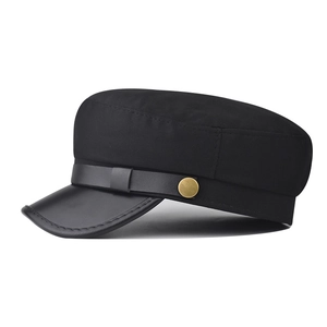 Black vintage captain hat with textured fabric and matte leather brim with gold button