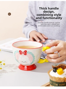 Detail of cute ceramic mug with embossed dog character and yellow heat-resistant handle