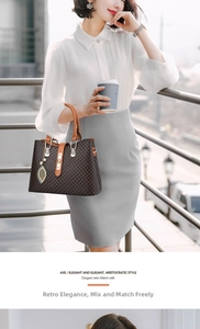 Detail of dark brown patterned tote bag with pearl leaf pendant on a city balcony