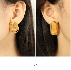 Detail of exaggerated gold-plated spiral hoops and mesh-textured oval earrings for women