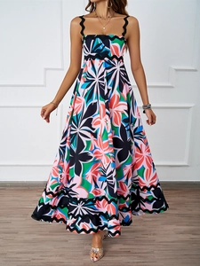 Close-up of abstract floral print and black wavy lace detailing on this summer maxi dress