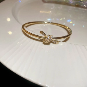 Macro view of 18k gold plated snake twist bracelet with shimmering zircon crystals