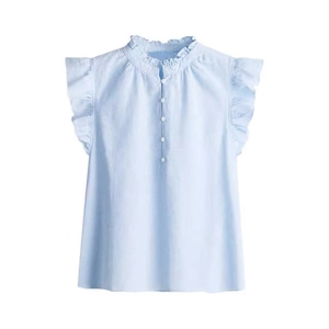 Close-up of light blue linen shirt featuring ruffle collar and flutter sleeves details