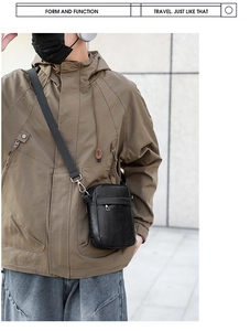 Close-up of black PU leather crossbody bag with adjustable strap on a street style model