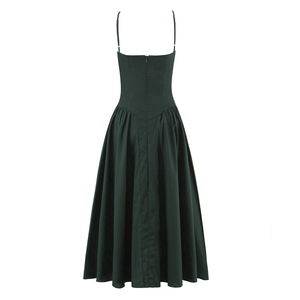 Deep green backless midi dress with thin straps and pleated A-line skirt on white background