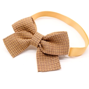 Classic checkered pet bowtie in brown and yellow fabric with adjustable satin strap on white back