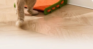 Close-up of durable orange and green felt cat scratcher pad with plastic buckle