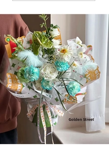 Close-up of bouquet with white roses and orchids tied with Merry Christmas ribbon