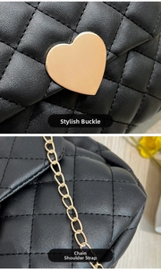 Detail view of black quilted leather texture with gold heart buckle and chain strap