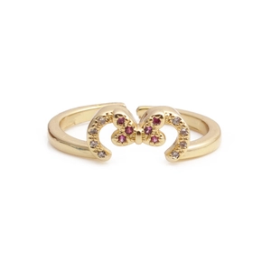 Adjustable golden butterfly ring with purple and white crystals on a white background