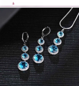 Close-up of blue teardrop zircon jewelry set with gradient stones and pavé crystals