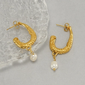 U-shaped gold earrings with irregular lava texture and hanging white pearls for women