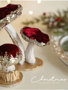 Detail of burgundy velvet Christmas mushrooms with gold sequins on a festive background