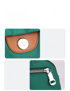 Dettaglio borsa nylon verde scuro con inserto in pelle, logo argento e cerniera metallica