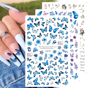 Blue butterfly nail stickers and floral decals with F679 design on natural hand model