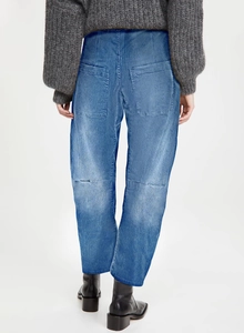 Detail of vintage high-waisted cargo jeans with back pockets and curved seam tailoring