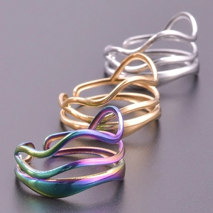 Macro shot of wavy multi-layered adjustable titanium rings in gold, silver and rainbow finish