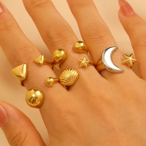 Celestial gold and silver ring set featuring moon star shell and geometric designs