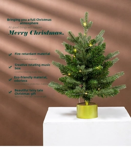 Tabletop rotating musical Christmas tree with warm LED lights and a golden base