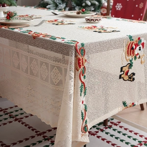 Lace Christmas tablecloth featuring embroidered Santa and reindeer motifs for festive dining