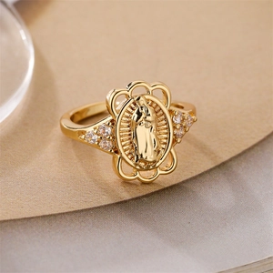 Macro shot of gold Virgin Mary oval relief ring with sparkling zircon side accents