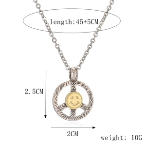 Macro detail of punk peace sign necklace with golden heart-eye smiley face pendant