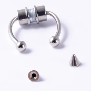 Detail of silver magnetic stainless steel septum ring with interchangeable ball and spike tips