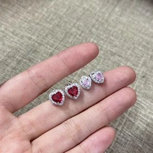 Macro shot of 18K gold plated heart earrings with pink gemstones and zircon accents