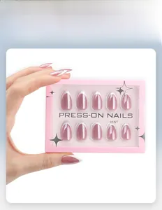 Detail of pink almond press-on nails with white French tips in a transparent window box