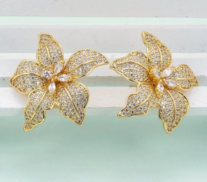 Luxury oversized flower stud earrings with shimmering cubic zirconia in gold plating