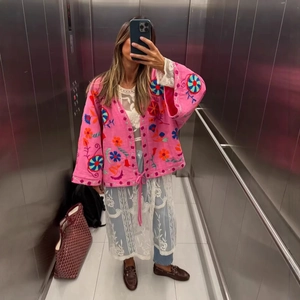 Pink boho cardigan with floral embroidery and loose fit for casual vacation style