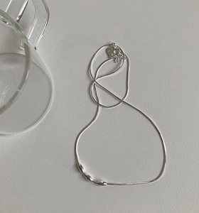 Detail of s925 silver snake chain necklace featuring three oval beads and lobster clasp