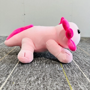Soft pink axolotl plush toy standing in side profile with pink gills and dorsal fin