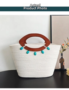 Detail of woven tote bag with wooden handles and turquoise beads on dark tabletop