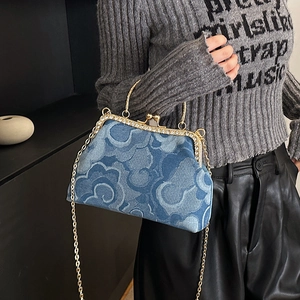 Blue denim handbag with cloud pattern, diamond metal frame, and gold chain strap