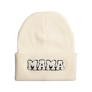 Detailed view of the soft MAMA chenille embroidery on a cozy cream knit beanie hat