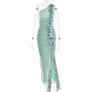 Detail of mint green ruched dress with ruffled trim and sexy asymmetric side slit
