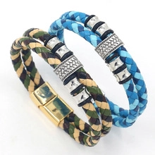 Detail of woven leather bracelets with skull charms and magnetic metal clasps