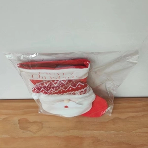 Detailed view of knitted Christmas stocking with 3D Santa Claus plush in packaging