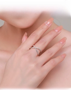 Detail of S925 sterling silver criss-cross ring with micro-pave cubic zirconia stones