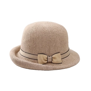 Women's beige knitted sun hat with a small brim and decorative ribbon bow accent