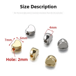 Detail of 7x6mm CCB heart beads in gold and silver showing precise 2mm center hole size