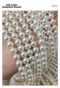 Macro shot of high-quality cream white glass pearls for DIY jewelry making accessories