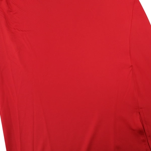 Close-up detail of red breathable textured fabric with side slit seam and pocket stitching