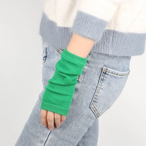 Close-up of bright green ribbed knit arm warmers made of soft textured cotton blend