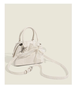 Vue détaillée du sac en relief crème avec texture marbrée et noeud en tulle doux