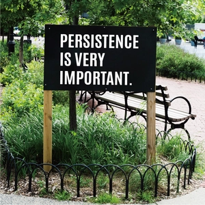 Detail of 3-inch waterproof letter stickers on garden signage with persistence quote