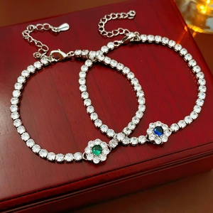 Close-up of S925 sterling silver flower bracelets with blue and green cubic zirconia