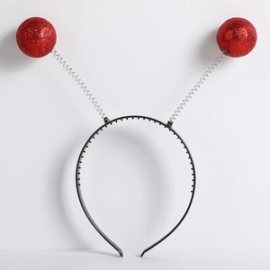 Detail of red glitter foam balls on spring antennas for alien headband party accessory