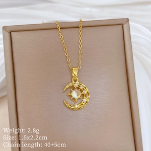 Detailed view of titanium moon and star pendant with colorful gem and 40cm chain